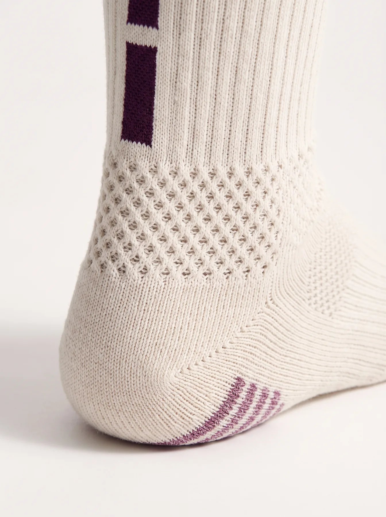 Honeycomb mesh panel at the back of the heel, below the dash bars
