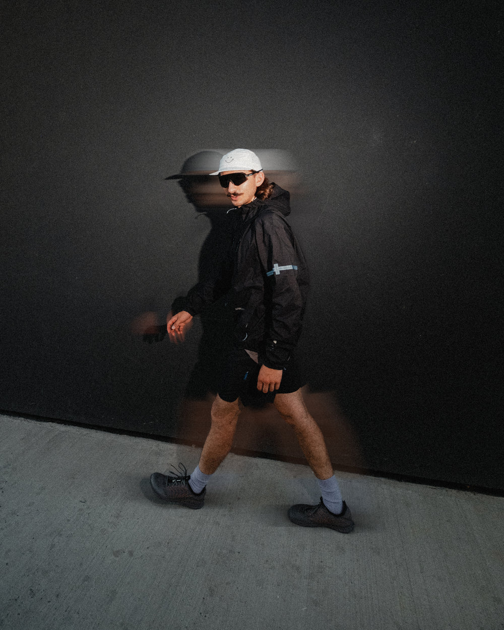 LONO VERVE in motion against a dark graphic wall