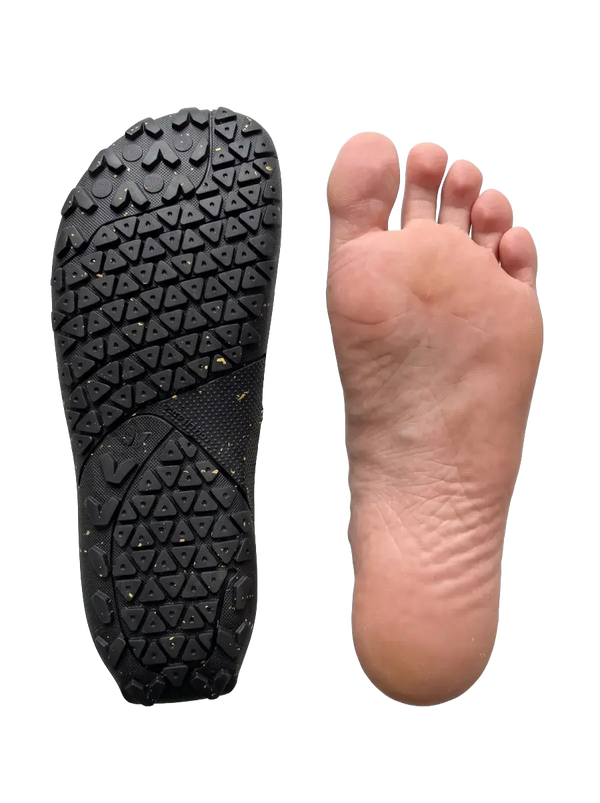 Shoe sole next to a bare foot, same size and shape